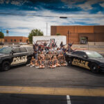 City of Abernathy high school twirlers, color guard, and drum majors with Abernathy police department vehicles